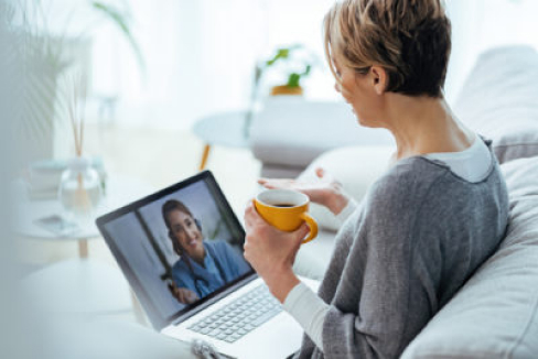 lady drinking coffee while zoom with doctor via telehealth