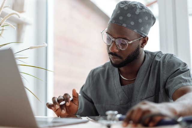 doctor working at laptop