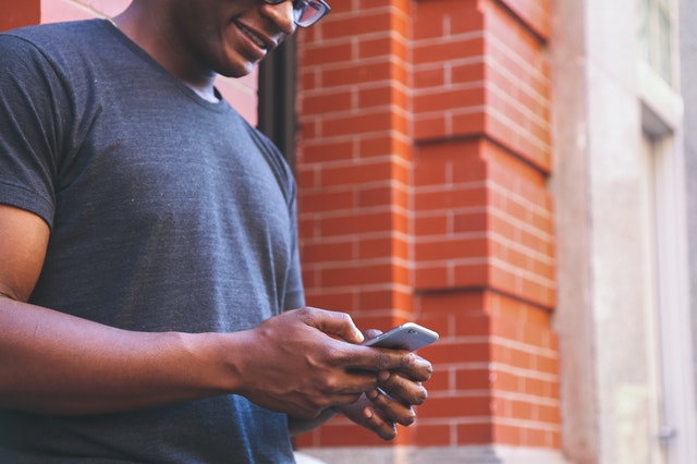 man booking appointment on cell phone