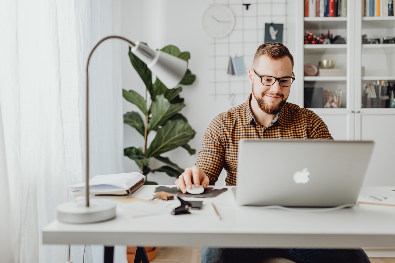 entrepreneur typing on laptop at desk