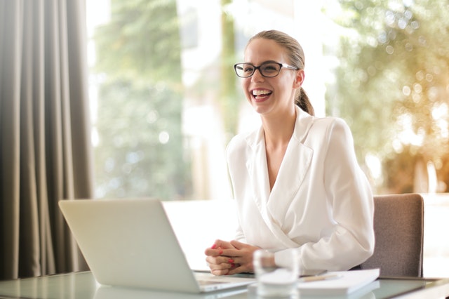 smiling entrepreneur working at laptop