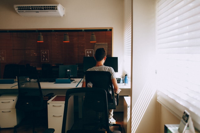 man sitting too much at work