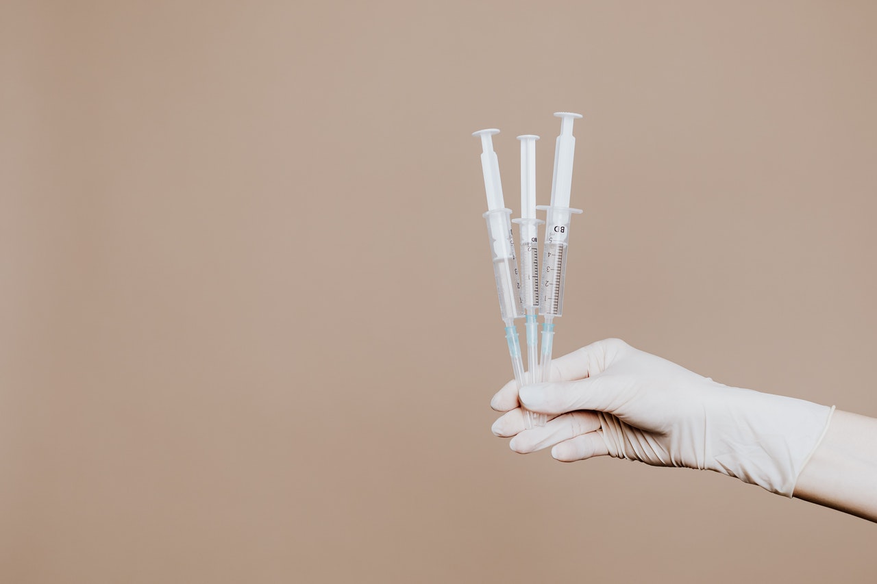 hand holding vaccines