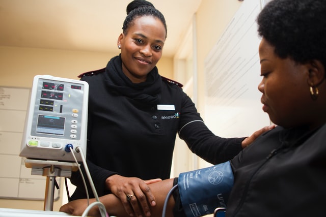 nurse taking patient's blood pressure