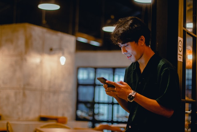 man texting on smartphone