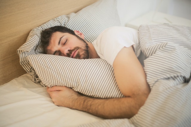 man asleep in bed