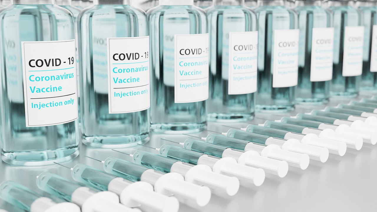 COVID-19 vaccine bottles and syringes