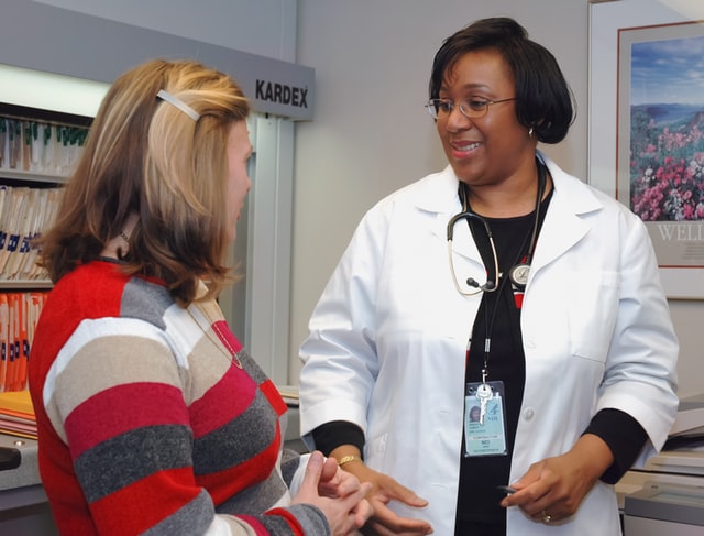 A female doctor speaking to a female patient
