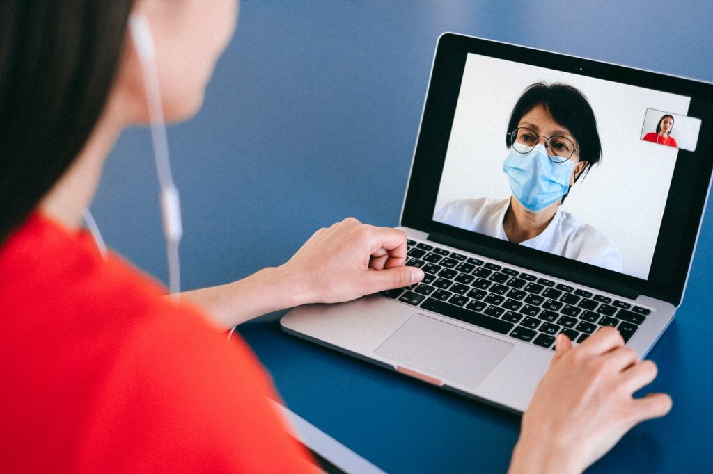patient doing video call with doctor on laptop