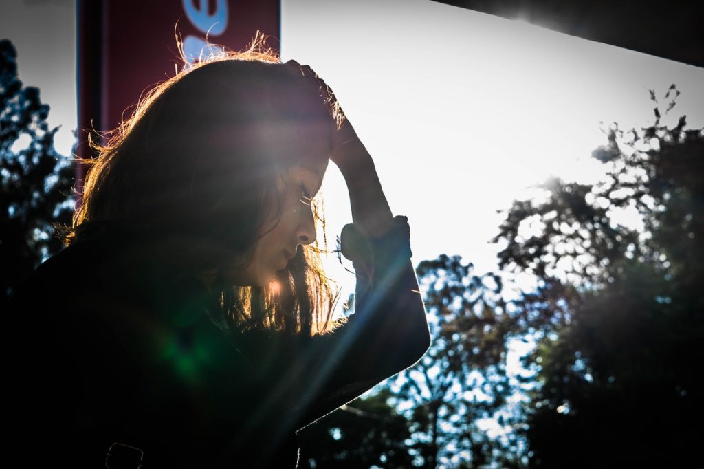 woman standing outside struggling with mental health issues