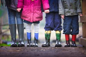 little kids legs wearing muddy boots
