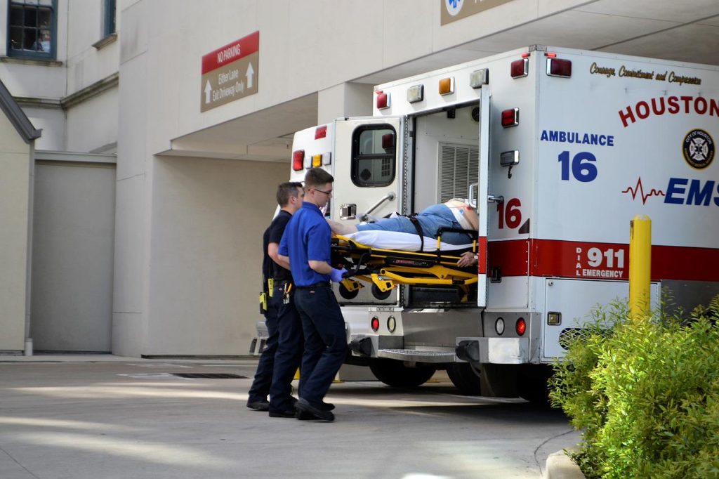 EMS taking man out of ambulance at emergency room