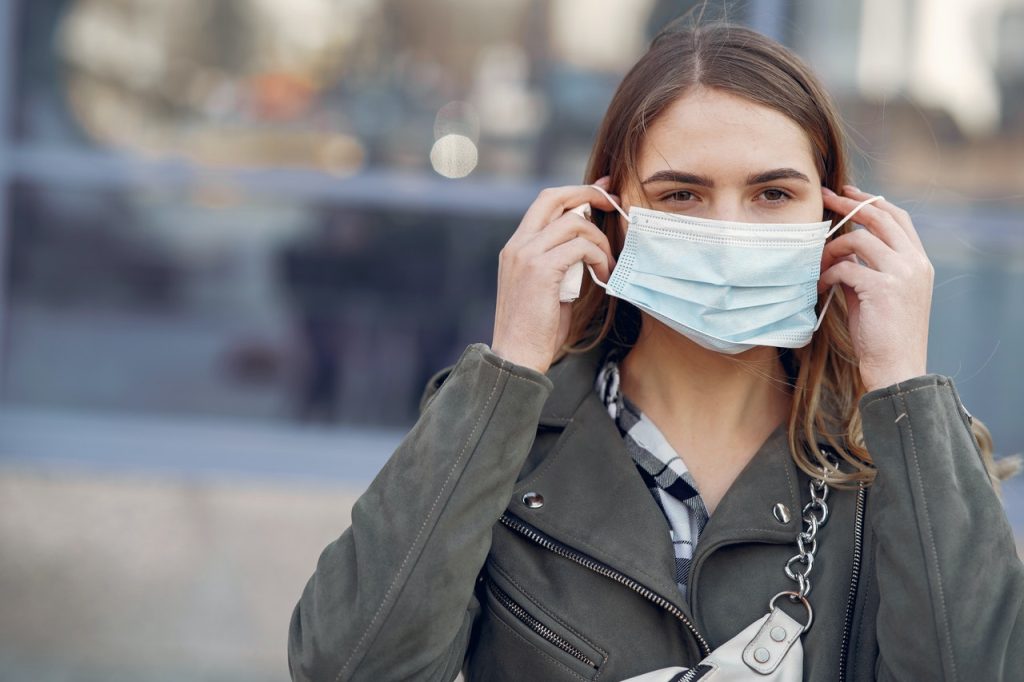 A woman wearing a face mask outdoors