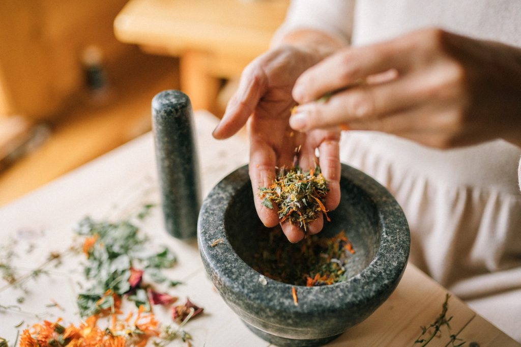 Grinding herbs into powder as alternative medicine
