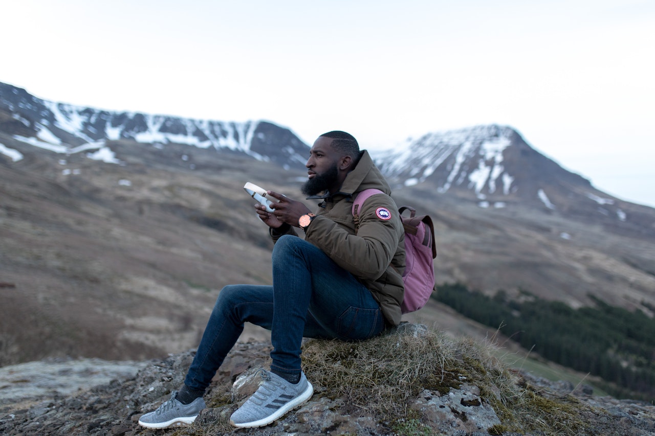Man in mountains listening to music