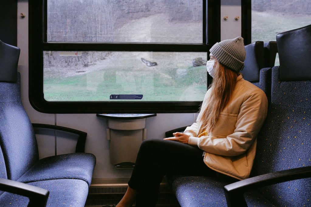 Woman on train wearing mask