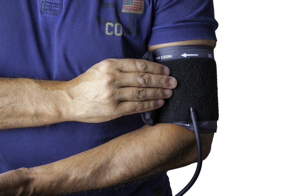 doctor putting on blood pressure cuff