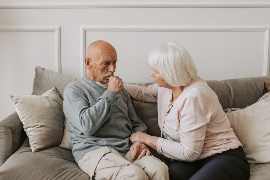 Elderlly man coughing due to COVID lung complications