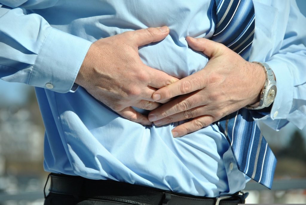 man clutching abdomen