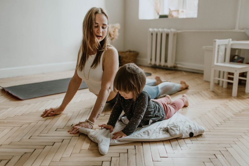 A mother and daughter exercising indoors