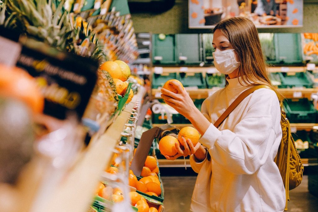 Woman wearing mask while grocery shopping