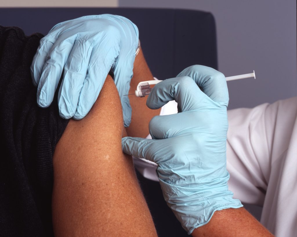 Doctor giving patient vaccine