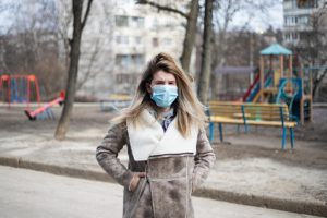 woman at playground wearing mask