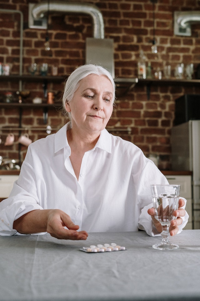 elderly woman taking antibiotics