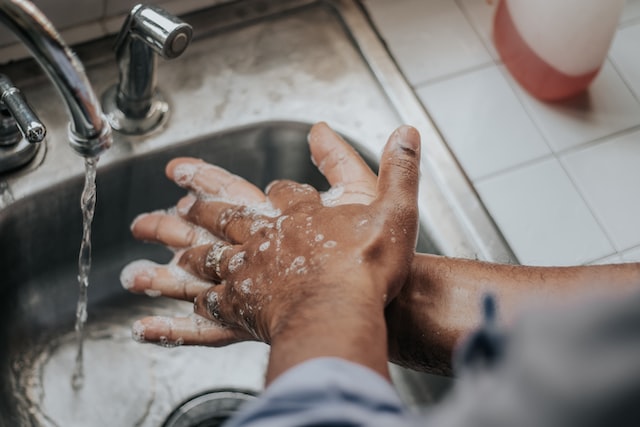 Man washing hands with soap and water