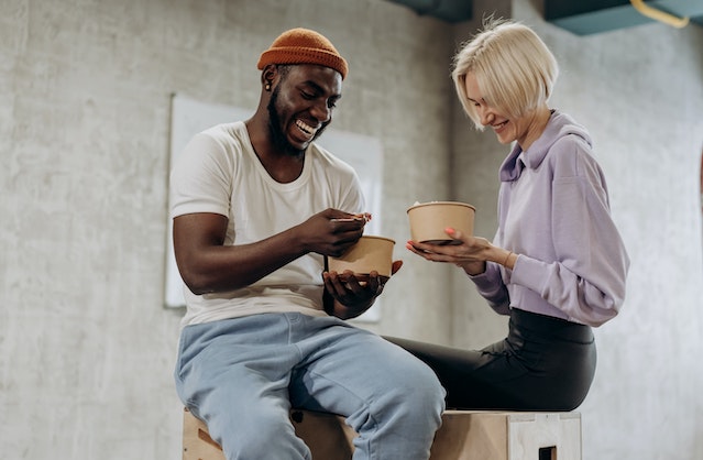 man and woman eating lunch