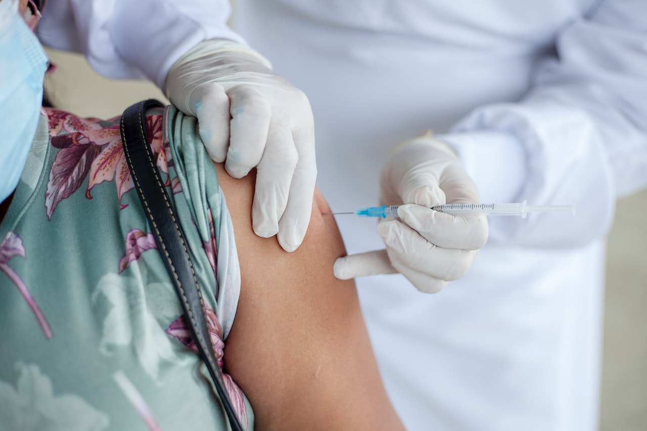 patient receiving vaccine from doctor