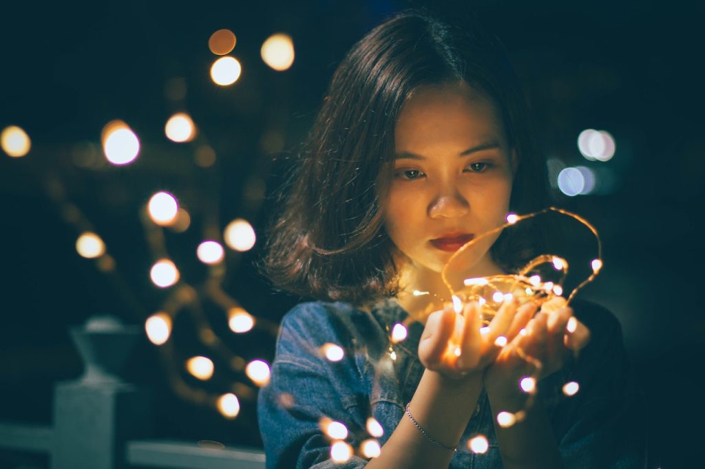 sad girl looking at holiday lights