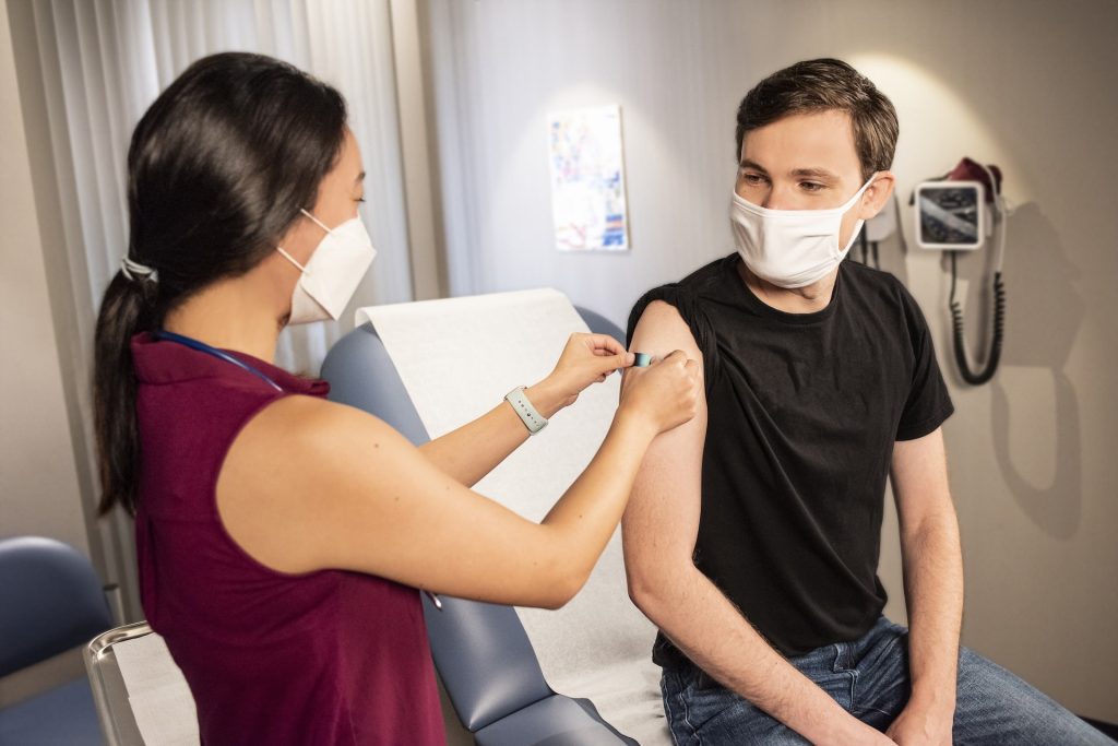 A female medical professional applying a bandage on a patient