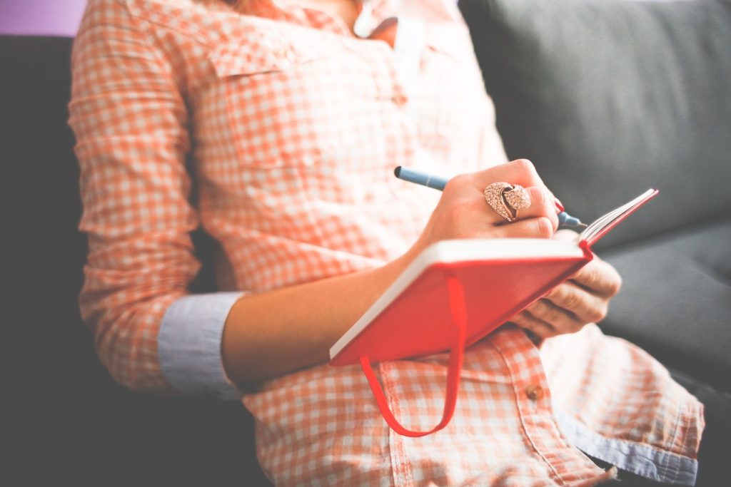 Woman logging her time in a journal