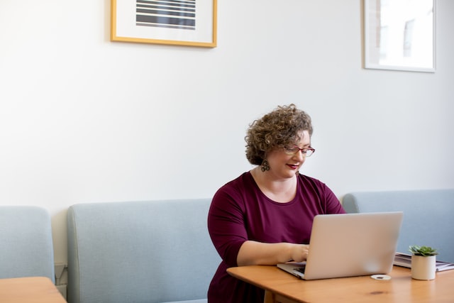 Woman scheduling a telehealth appointment on her laptop
