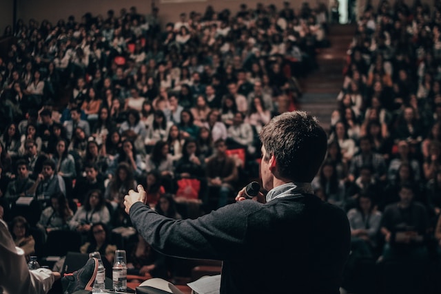Entrepreneur speaking to packed audience onstage