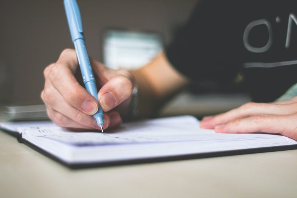 business owner writing down SOP in a notebook