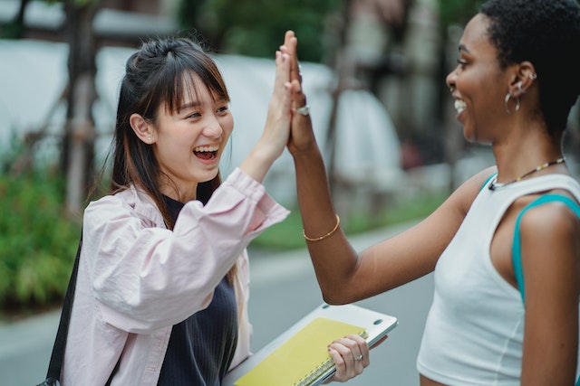 two women giving a high five