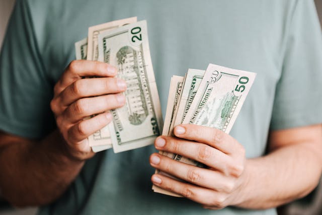 Business owner counting money for his bank account